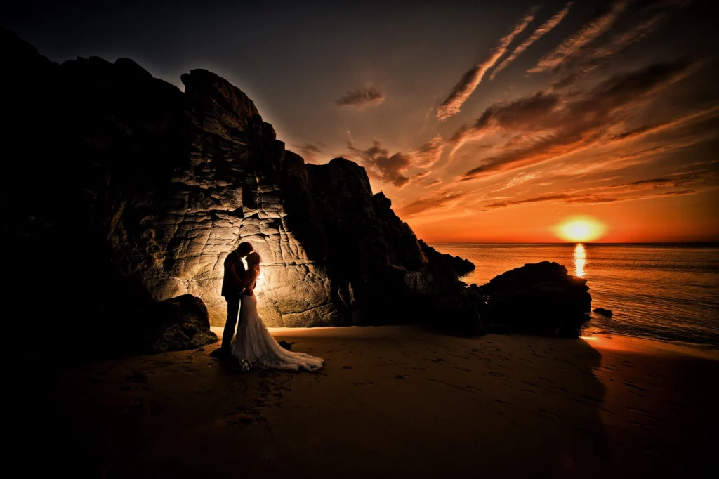 Couple de mariés, en bord de mer, couché de soleil
