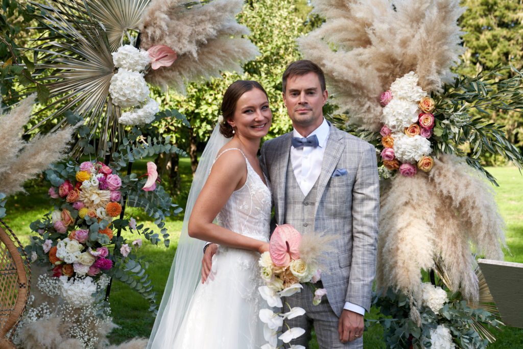 Couple de mariés avec un décor de fleurs et pampa en bretagne par le studio faucher